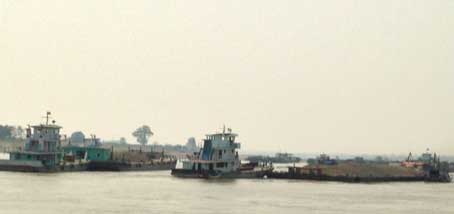 Big boat dragging pebble and sand